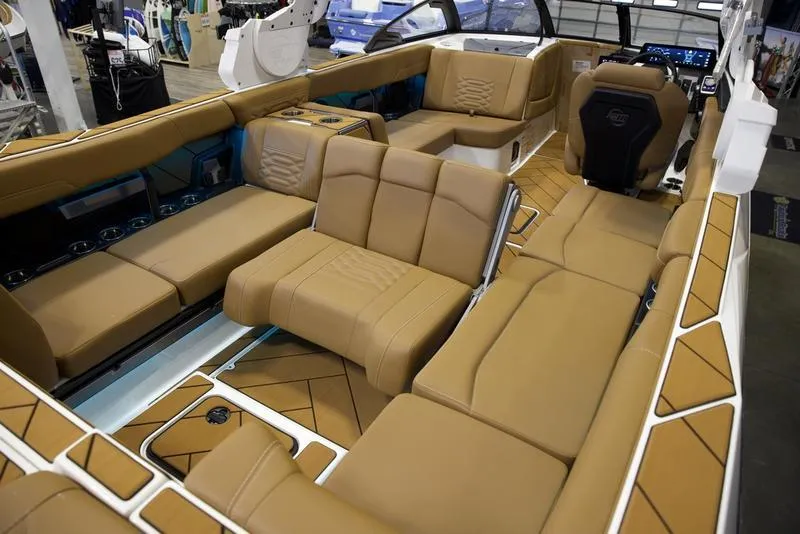 Slide: The Image of Luxurious interior of 2025 Malibu 26 LSV boat with tan leather seating. - 28