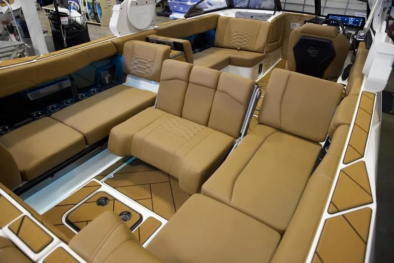 Slide: The Image of 2025 Malibu 26 LSV boat interior with luxurious tan seating and modern design. - 29