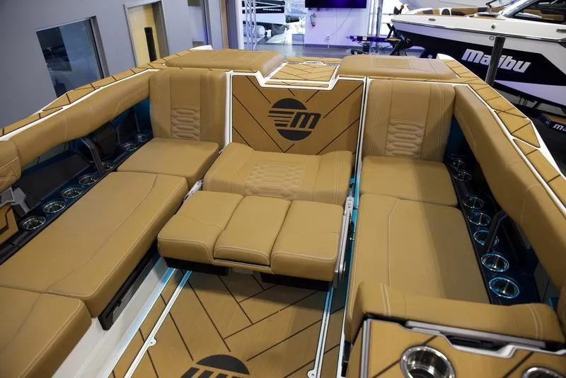 Slide: The Image of Luxurious interior of 2025 Malibu 26 LSV boat with tan seating and modern design. - 30