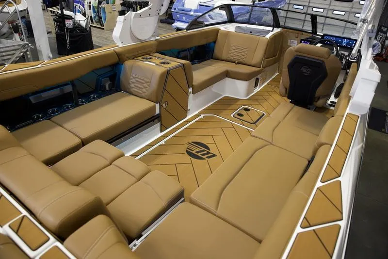Slide: The Image of Luxurious interior of 2025 Malibu 26 LSV boat with tan seating and modern design. - 32