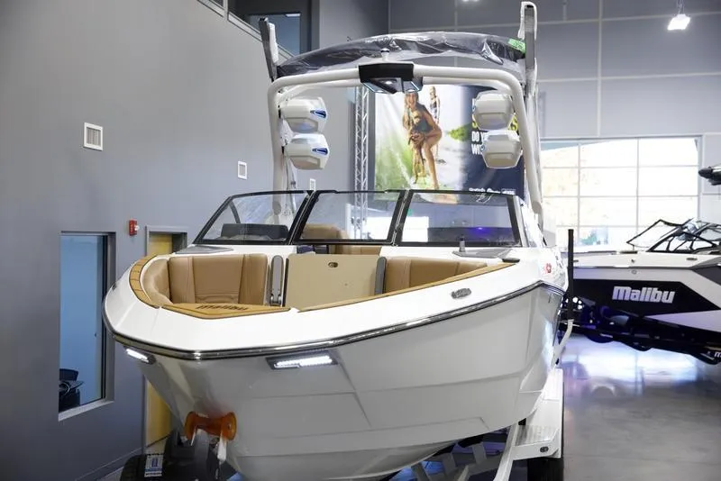 Slide: The Image of 2025 Malibu 26 LSV boat in showroom, featuring sleek design and modern amenities. - 4