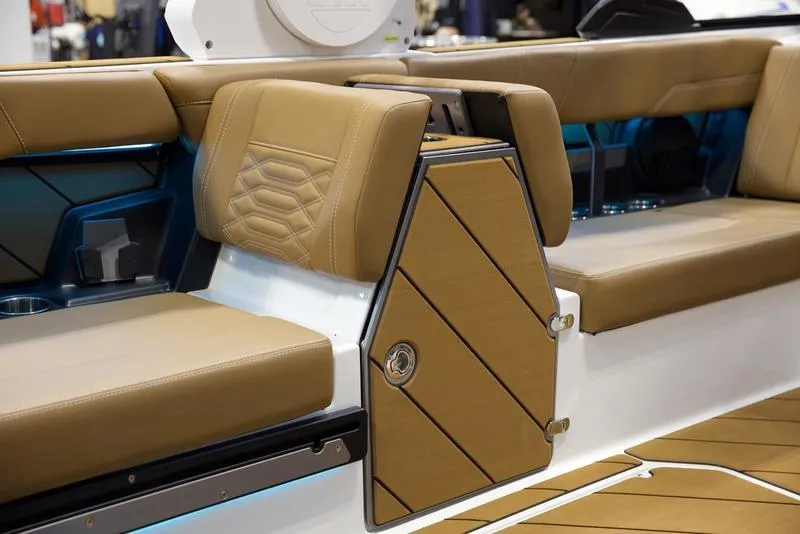 Slide: The Image of 2025 Malibu 26 LSV boat interior with tan leather seating and modern design. - 7