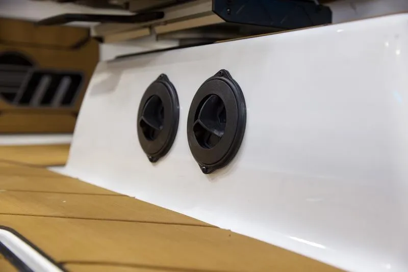 Slide: The Image of 2025 Malibu 26 LSV boat interior with dual speakers on white panel. - 8