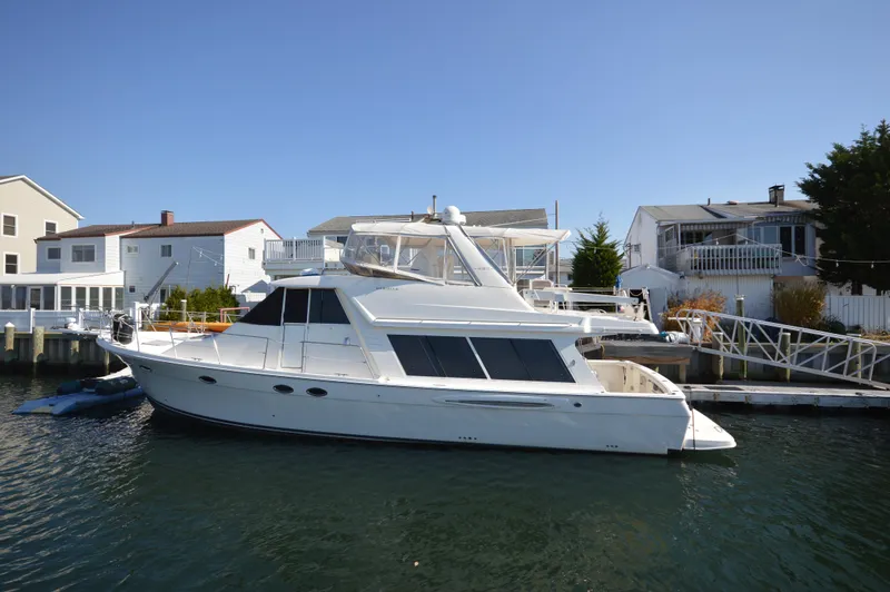 The Image of 2007 Meridian 490 Pilothouse yacht docked near waterfront homes. - 1