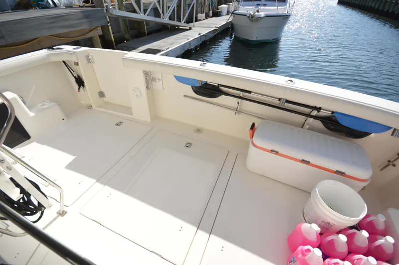 Slide: The Image of 2007 Meridian 490 Pilothouse boat deck with storage, cooler, and cleaning supplies. - 12