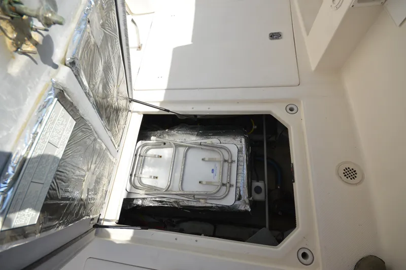 Slide: The Image of Engine compartment of 2007 Meridian 490 Pilothouse yacht, showing insulated access hatch. - 14
