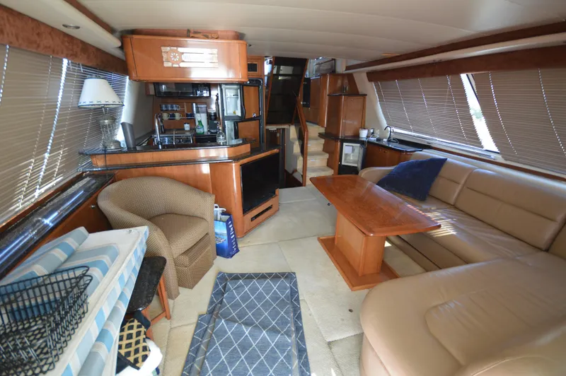 Slide: The Image of Luxurious 2007 Meridian 490 Pilothouse interior with leather seating, wooden table, and modern amenities. - 16