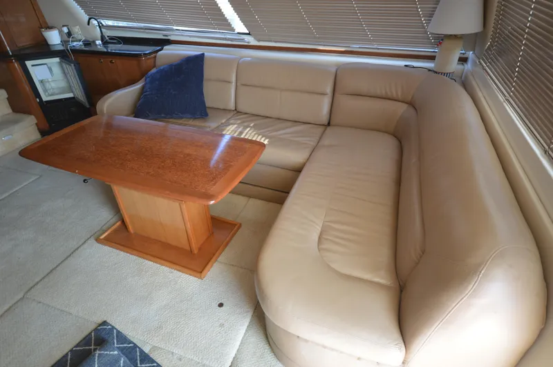Slide: The Image of Luxurious interior of 2007 Meridian 490 Pilothouse with beige leather sofa and wooden table. - 17