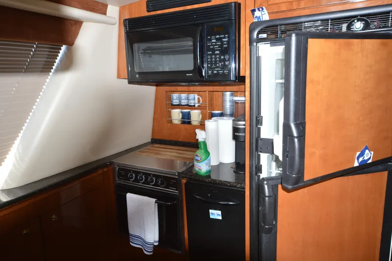 Slide: The Image of 2007 Meridian 490 Pilothouse kitchen with microwave, stove, and refrigerator. - 20