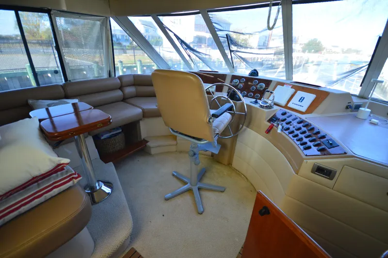 Slide: The Image of 2007 Meridian 490 Pilothouse interior with helm, seating, and navigation controls. - 30