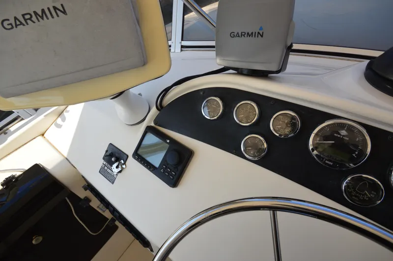 Slide: The Image of 2007 Meridian 490 Pilothouse dashboard with Garmin navigation and control instruments. - 34