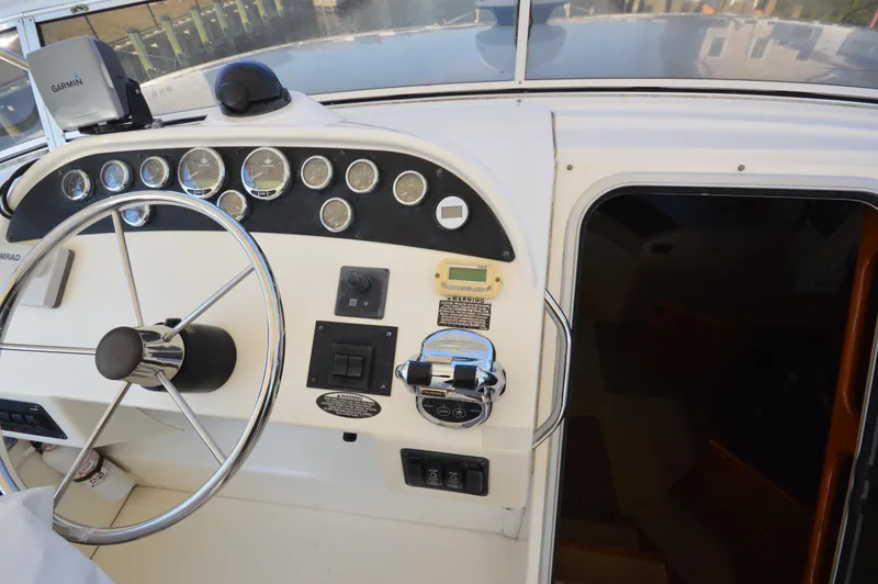 Slide: The Image of 2007 Meridian 490 Pilothouse dashboard with steering wheel and navigation instruments. - 35