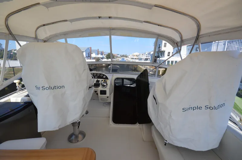 Slide: The Image of 2007 Meridian 490 Pilothouse interior with covered seats and control panel. - 36