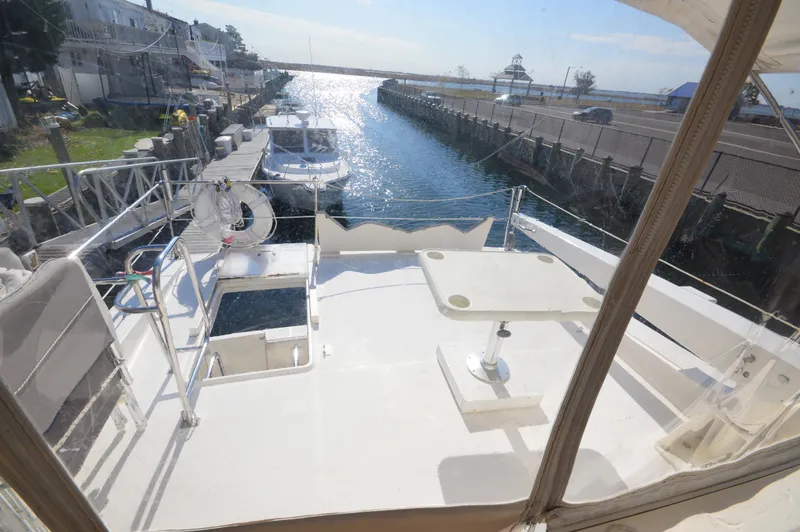 Slide: The Image of 2007 Meridian 490 Pilothouse yacht docked in a sunny marina. - 37