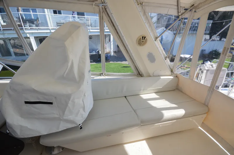 Slide: The Image of 2007 Meridian 490 Pilothouse interior with white seating and covered equipment. - 40
