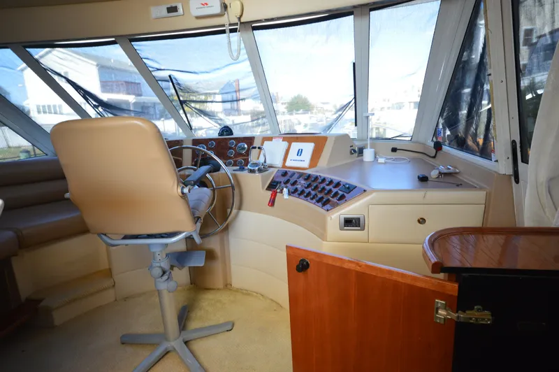 Slide: The Image of 2007 Meridian 490 Pilothouse interior with steering wheel and control panel. - 41
