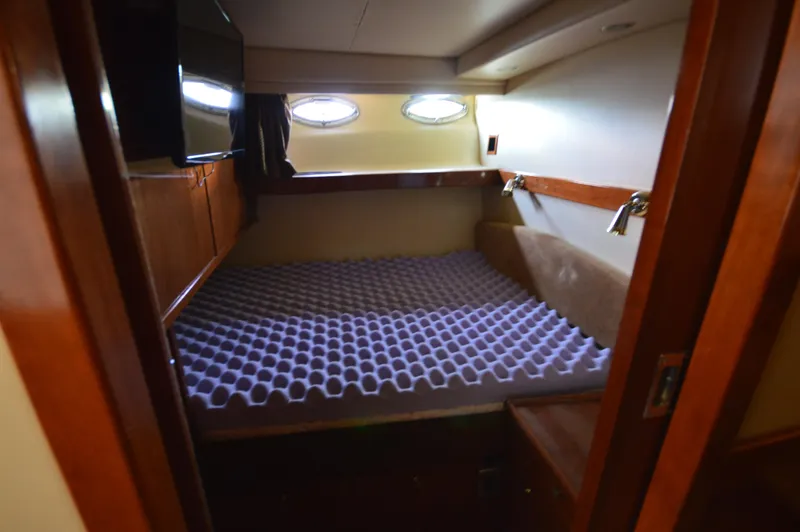 Slide: The Image of Cozy cabin interior of 2007 Meridian 490 Pilothouse with bed and porthole windows. - 42