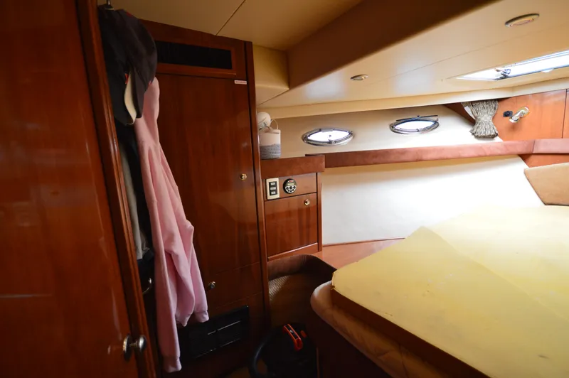 Slide: The Image of Interior cabin of 2007 Meridian 490 Pilothouse yacht with wood paneling and portholes. - 47
