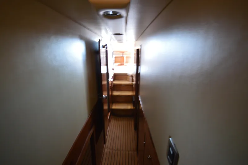 Slide: The Image of Narrow hallway inside 2007 Meridian 490 Pilothouse yacht with wooden flooring and stairs. - 49