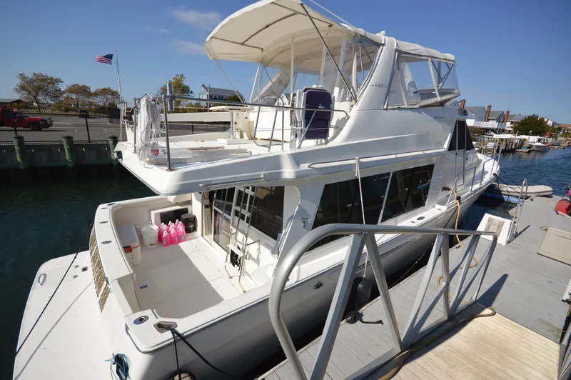 Slide: The Image of 2007 Meridian 490 Pilothouse yacht docked at marina, featuring spacious deck and pilothouse. - 8
