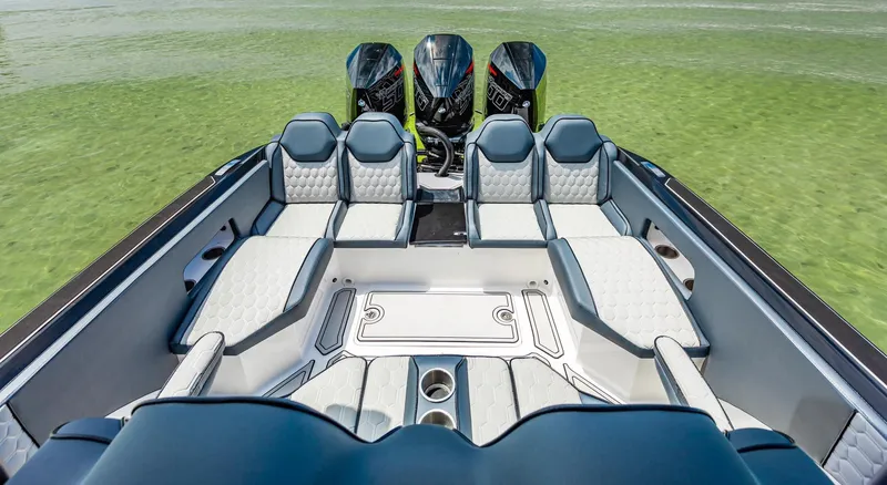 Slide: The Image of 2025 Glasstream GSX 360 LS boat interior with luxurious seating and triple outboard engines. - 11