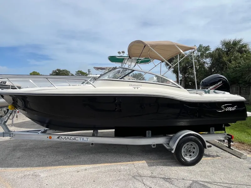 The Image of 2021 Scout 210 Dorado boat on trailer with canopy, parked outdoors. - 0