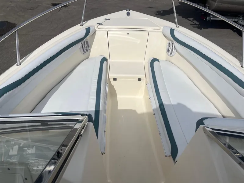 Slide: The Image of 2021 Scout 210 Dorado boat on trailer with canopy, parked outdoors. - 1