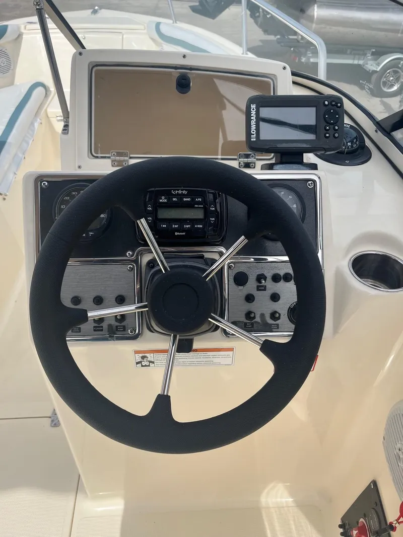 Slide: The Image of 2021 Scout 210 Dorado boat interior with white and blue seating. - 2