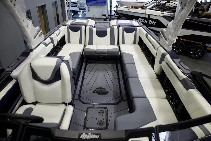 Slide: The Image of 2025 Malibu 25 LSV boat interior with luxurious seating and modern design. - 10
