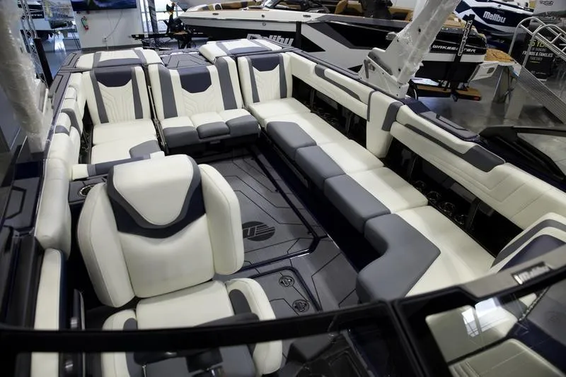 Slide: The Image of 2025 Malibu 25 LSV boat interior with luxurious seating and modern design. - 12