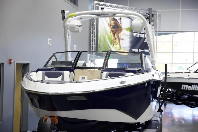 Slide: The Image of 2025 Malibu 25 LSV boat displayed indoors, showcasing sleek design and modern features. - 14