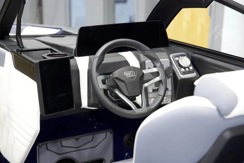 Slide: The Image of 2025 Malibu 25 LSV boat interior with modern steering wheel and dashboard. - 16