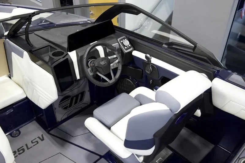 Slide: The Image of 2025 Malibu 25 LSV boat interior with modern steering and seating design. - 17