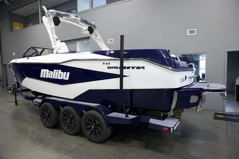 Slide: The Image of 2025 Malibu 25 LSV boat on trailer in showroom. - 19
