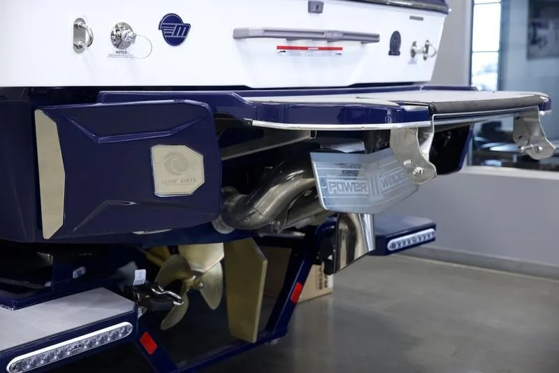 Slide: The Image of 2025 Malibu 25 LSV boat rear view showcasing propeller and exhaust system. - 4