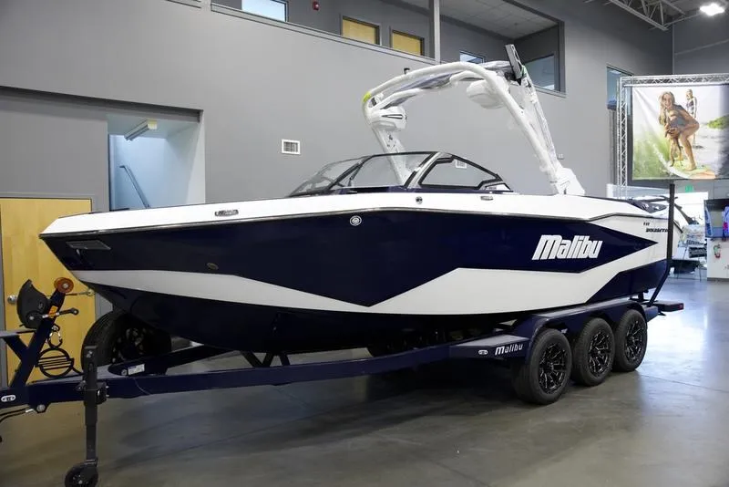 Slide: The Image of 2025 Malibu 25 LSV boat on trailer in showroom. - 8