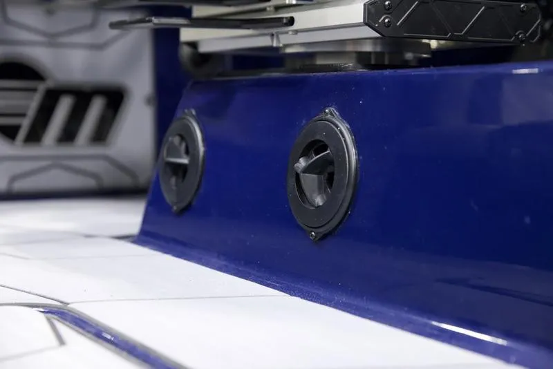 Slide: The Image of Close-up of 2025 Malibu 25 LSV boat interior with blue panel and speaker vents. - 9