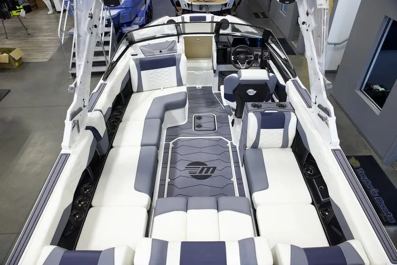 Slide: The Image of 2025 Malibu 24 MXZ boat interior with luxurious seating and modern design. - 12