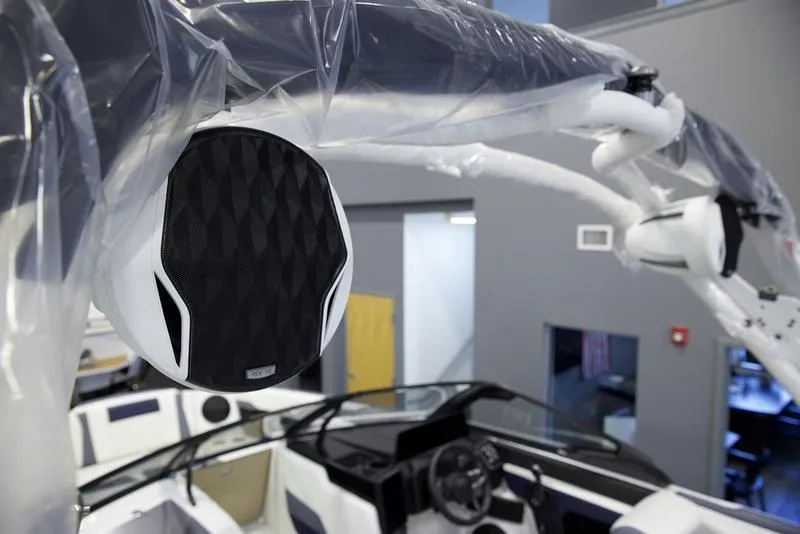 Slide: The Image of 2025 Malibu 24 MXZ boat interior with premium audio system and sleek design. - 13