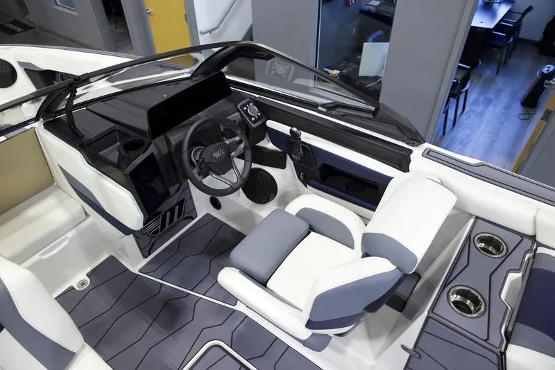 Slide: The Image of 2025 Malibu 24 MXZ boat interior with modern dashboard and seating. - 14