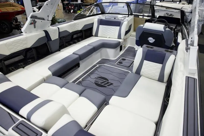 Slide: The Image of 2025 Malibu 24 MXZ boat interior with luxurious seating and modern design. - 19