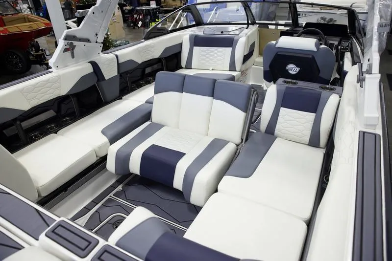 Slide: The Image of 2025 Malibu 24 MXZ boat interior with luxurious white and gray seating. - 20