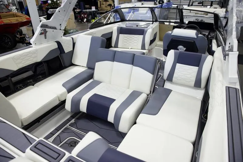 Slide: The Image of 2025 Malibu 24 MXZ boat interior with luxurious seating and modern design. - 21