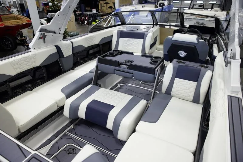 Slide: The Image of 2025 Malibu 24 MXZ boat interior with luxurious seating and modern design. - 22