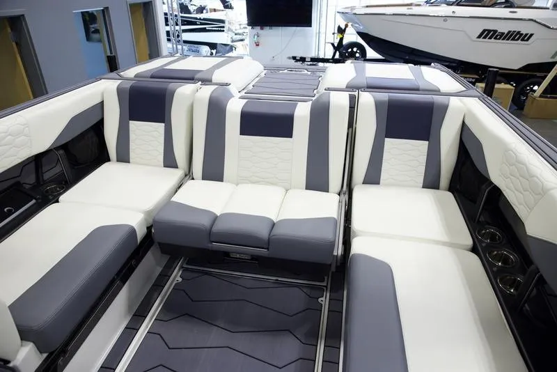 Slide: The Image of 2025 Malibu 24 MXZ boat interior with luxurious seating and modern design. - 25