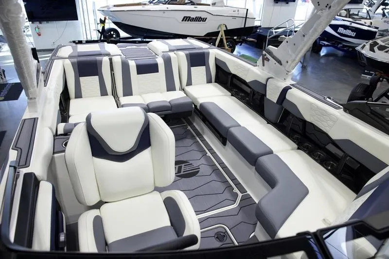 Slide: The Image of 2025 Malibu 24 MXZ boat interior with luxurious seating and modern design. - 26