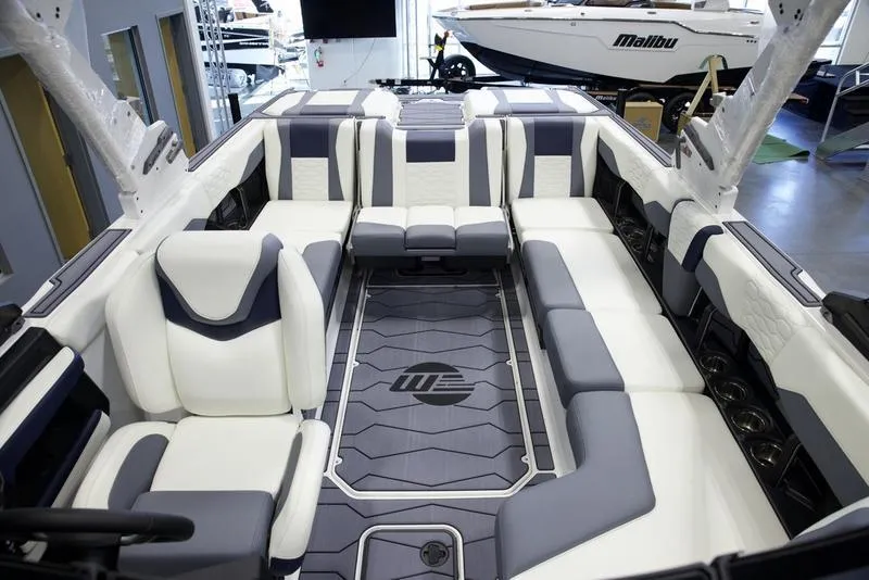 Slide: The Image of 2025 Malibu 24 MXZ boat interior with luxurious seating and modern design. - 27