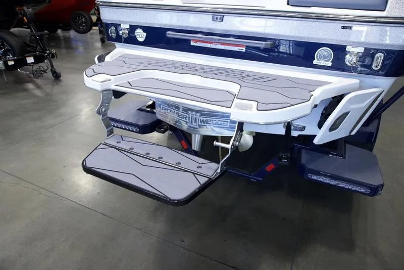 Slide: The Image of 2025 Malibu 24 MXZ boat rear view with swim platform and step. - 6