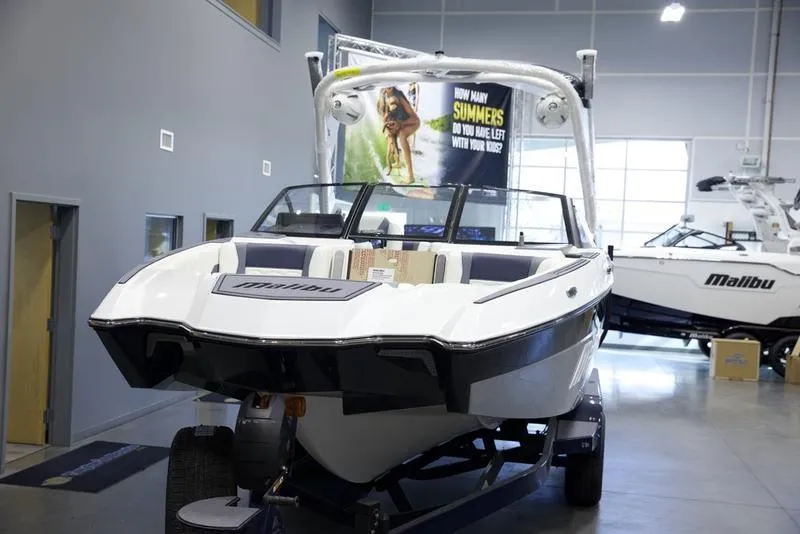 Slide: The Image of 2025 Malibu 24 MXZ boat displayed in a showroom, highlighting sleek design and modern features. - 8