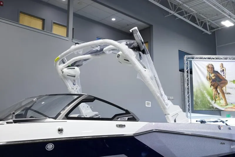 Slide: The Image of 2025 Malibu 24 MXZ boat with sleek design and advanced wakeboard tower. - 9